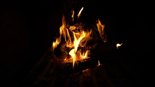 Slow motion video of cosy fireplace with reddish fire during holidays