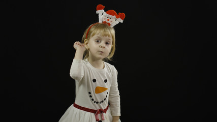 Happy beautiful baby girl in snowman costume. Christmas. Make faces, dance
