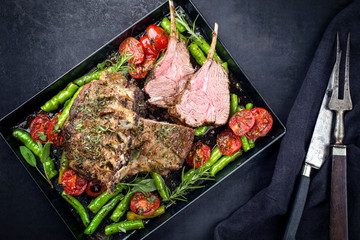 Barbecue rack of lamb neck with paprika and tomato offered as top view on a metal tray with copy space