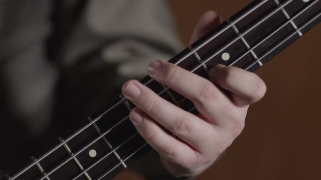 Bass electric guitar playing with the left hand