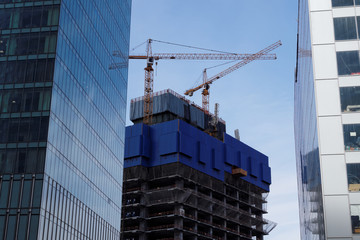 Fototapeta premium Cranes on the construction site of skyscraper