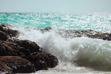 Waves crashing on rocks on a beach