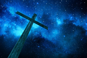 wooden cross under stars in the night sky