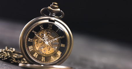 Antique old pocket watch dial close-up. Vintage hipster clock measuring time.