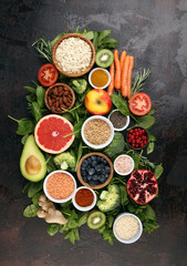 Fototapeta na wymiar Healthy food clean eating selection: fruit, vegetable, seeds, superfood, cereals, leaf vegetable on rustic background