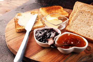 Toast bread on rustic table served with butter for breakfast or brunch. Toasted bread