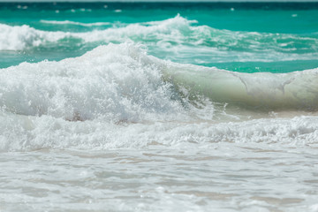 Waves crashing on rocks on a beach