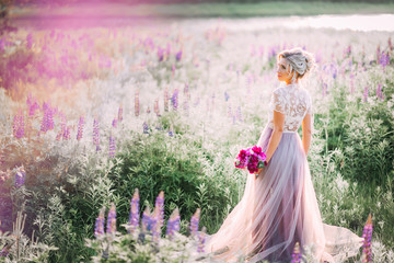 glamour and joyful woman in the flowering field, in harmony with nature