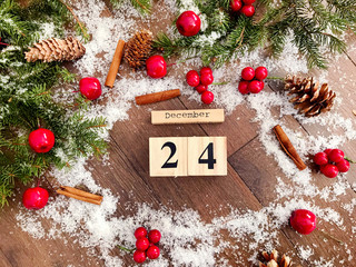 Christmas Card with Pine Branches ,Wooden Snowman and Wooden Calendar with 24 of December Date  .Christmas Concept