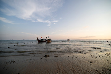 Fototapeta na wymiar Sunset in the beach with a boat, Thailand 