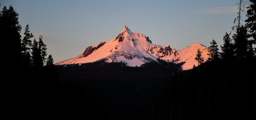 Mount Jefferson Alpenglow at Sunset with Silhouetted Pine Forest, Oregon © brendan