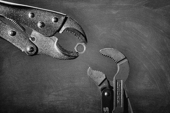 Creative image of plumbing wrenches as birds on gray background