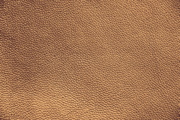 The texture of genuine leather. Impeccable and stylish background. Beautiful stylish background. Natural skin texture close up. Brown background. The structure of the leather material brown shades