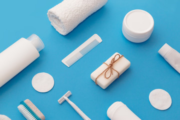 Body and skin hygienic care toiletry products, in white packaging on a blue background. Flat lay. Copy space