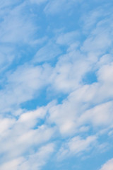 White clouds in the blue sky. Background. Texture. Vertical format