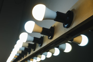 bright lamps in a row on the make-up mirror for makeup artists and actors