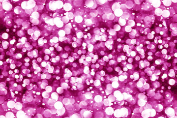 Pink bokeh shiny glitter background. Abstract vibrant color glowing white spots texture for graphic design.