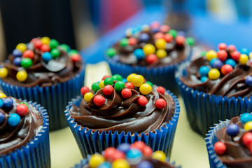 Close up of chocolate cupcakes with colorful balls.