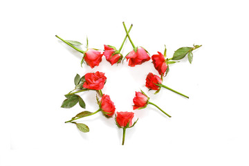 red roses laid in a heart shape isolated on a white background, love concept with copy space