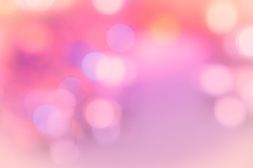 Fototapeta premium Abstract rose quartz pink to pale ultra violet purple and yellow orange blurred neon light circles photo background. Soft elegant blur - landscape design wedding invitation wallpaper.