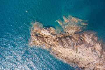 aerial view of the rocky cape surrounded by turquoise water