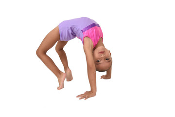 small latin girl doing gymnastics with white background and purple sportswear