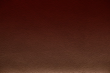 The texture of genuine leather. Impeccable and stylish background. Beautiful stylish background. Natural skin texture close up. Brown background. The structure of the leather material brown shades