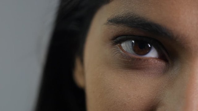 Serious expression in a young woman's eyes