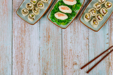Delicious sushi and rolls with chopstick for party.