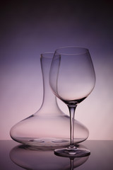 Glassware selection with wine glass and decanter on creative background. Fine cristal glassware concept. Vertical, warm tone