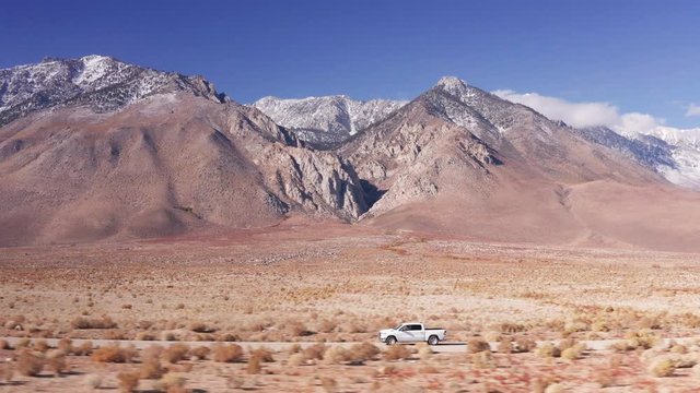 Aerial Drone Tracking a Pickup Truck with Mountains in Death valley Nevada USA