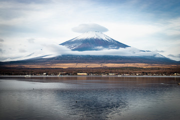 Fujisan or Fuji mountain and the cloud at the top that look like wearing the hat.