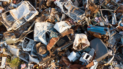 A view of a large pile of scrap metal at a junkyard or recycling plant.