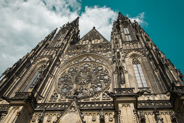 Fototapeta premium Stunning gothic Saint Vitus Cathedral against teal blue cloudy sky (Czech: Chram Svateho Vita, Prazsky Hrad), seat of the Archbishop of Prague - Roman Catholic Church - Prague Castle complex