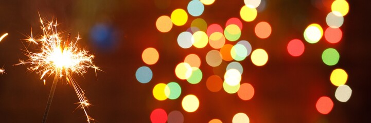 beautiful sparklers on the background of a garland. beautiful banner for the New Year.