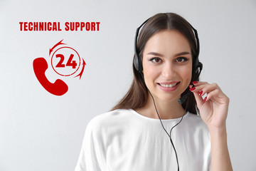 Female technical support agent on light background