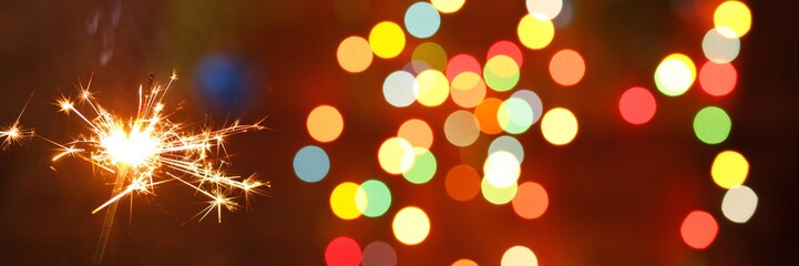 beautiful sparklers on the background of a garland. beautiful banner for the New Year.