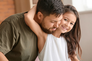 Fototapeta premium Portrait of father with little daughter at home