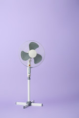 Electric fan on color background