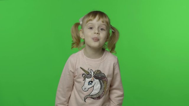 Girl in unicorn sweatshirt show tongue and smile. Happy child. Chroma Key