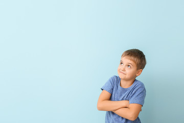 Cute little boy on color background