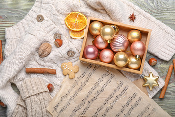 Christmas composition with music sheets on wooden background