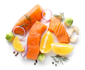 Raw salmon fillet, lemon and spices on white background