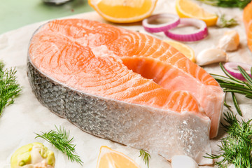 Raw salmon steak on table