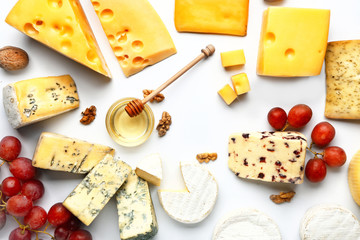 Assortment of fresh cheeses on white background