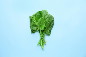 Fresh spinach on color background