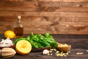 Ingredients for pesto sauce on wooden background