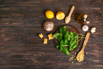 Ingredients for pesto sauce on wooden background