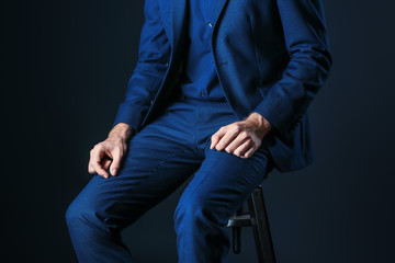 Man in stylish blue clothes on dark background
