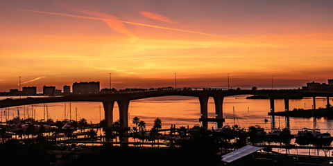 Fototapeta premium View of a harbor and bridge as the sun sets in Clearwater, Florida